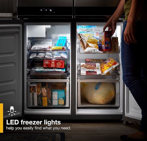 Whirlpool WRQA59CNKZ French door refrigerator freezer open with LED lights on