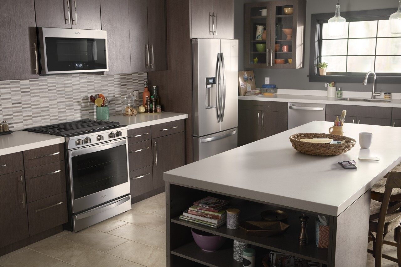 high end kitchen with dark cabinets and whirlpool appliances