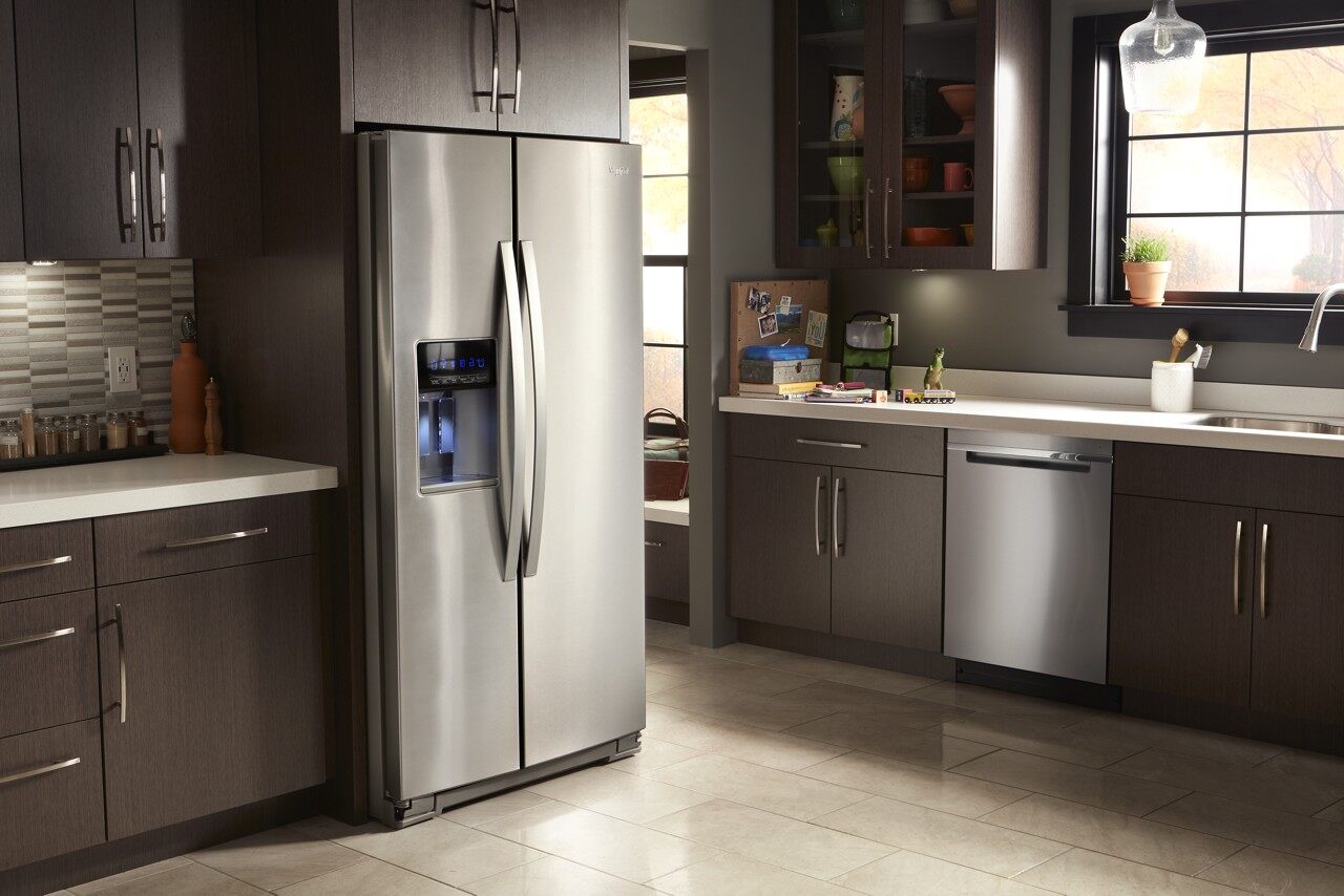 Family kitchen featuring dark cabinetry and whirlpool WRS571CIHZ side by side refrigerator