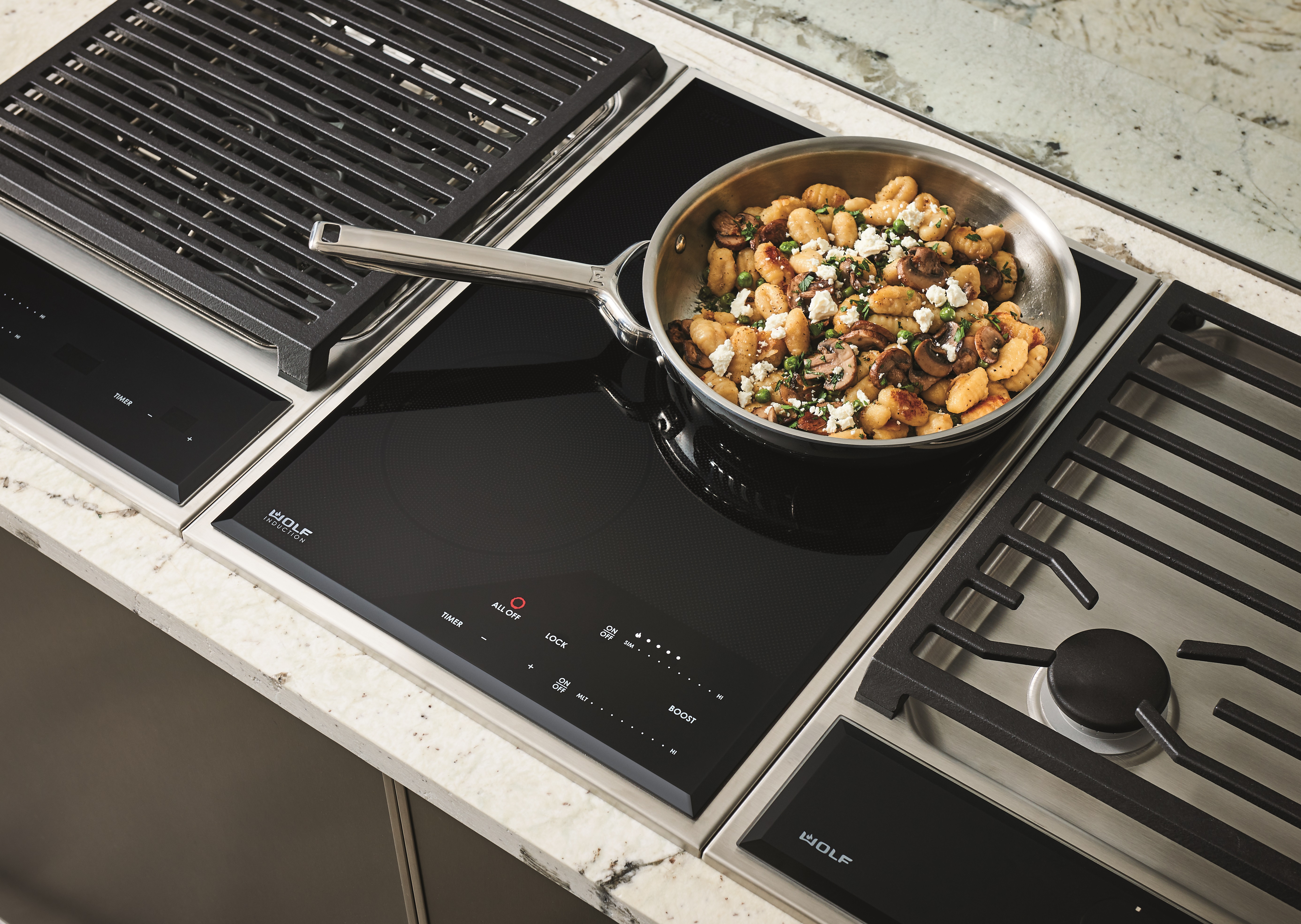 Overhead shot of a pan with gnocchi cooking on a Wolf module cooktop