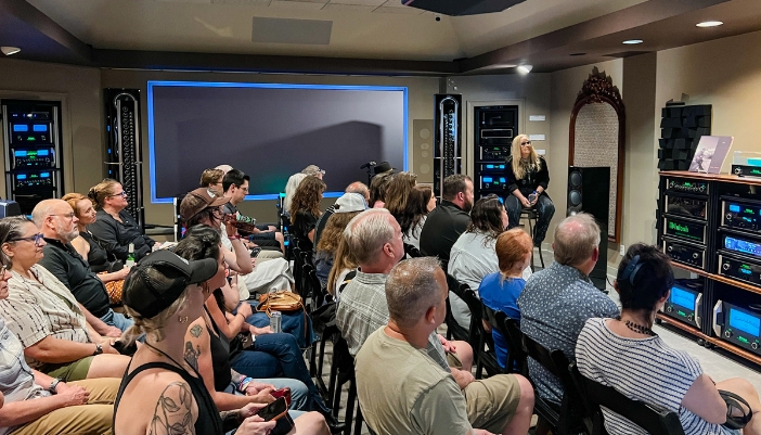 A group of people at an event with a singing artist