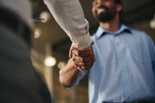 Professional smart home installer shaking hands with client Professional smart home installer shaking hands with client