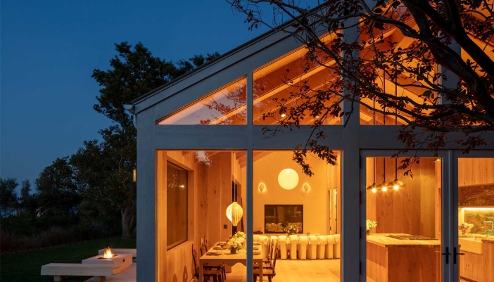 An exterior shot of a home with warm lighting inside.