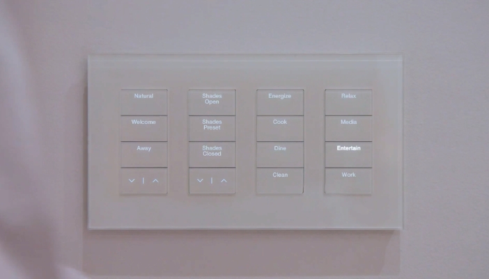 A white keypad for lighting on a white wall. 