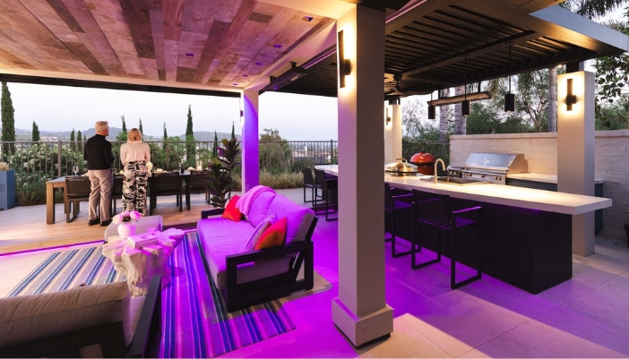 An outdoor patio space with purple lighting.