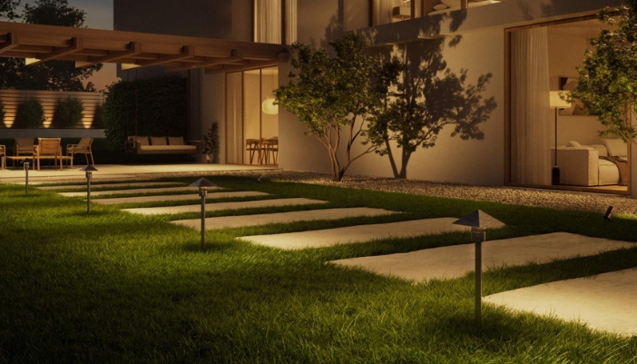 An outdoor pathway lit with small lights.
