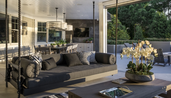 An outdoor space with black furniture and natural lighting.