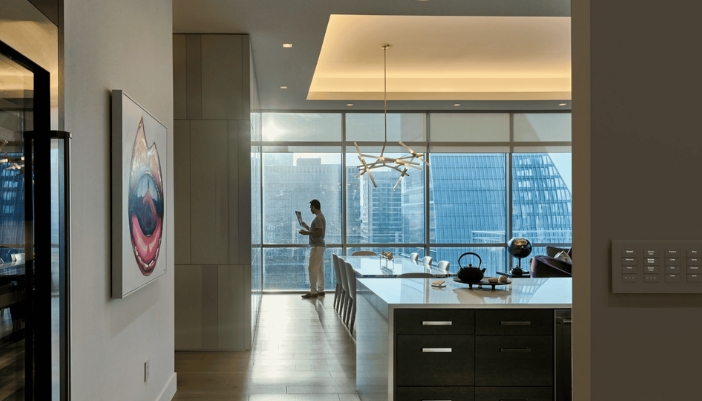 A man in a modern home with smart home designs present.