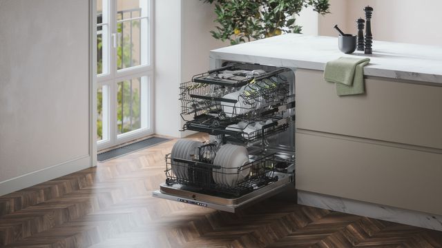 Front view of a modern kitchen with an opened ASKO dishwasher