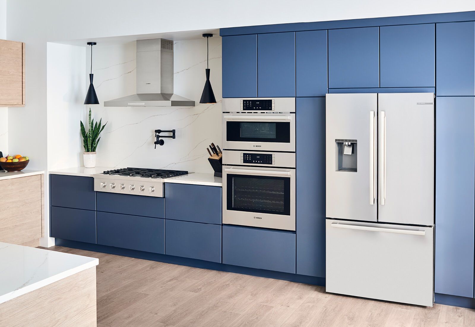 Open Bosch four-door refrigerator showing the organized two-tiered freezer drawers Open Bosch four-door refrigerator showing the organized two-tiered freezer drawers