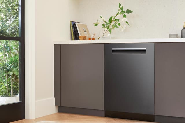 Front view of a modern kitchen with a black stainless steel Bosch dishwasher Front view of a modern kitchen with a black stainless steel Bosch dishwasher