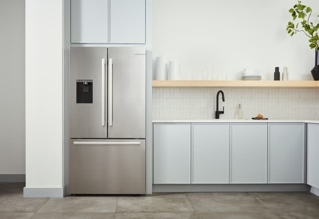 Front view of a modern kitchen with a built in Bosch refrigerator