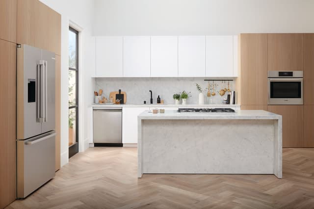 Front view of a modern kitchen with Bosch stainless steel appliances Front view of a modern kitchen with Bosch stainless steel appliances