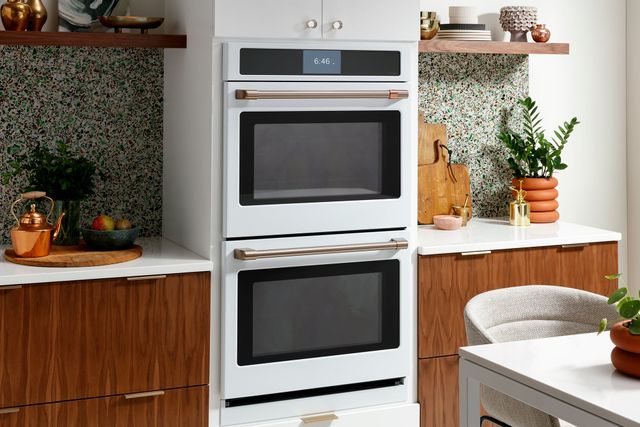 Front view of a white and gold Cafe double oven