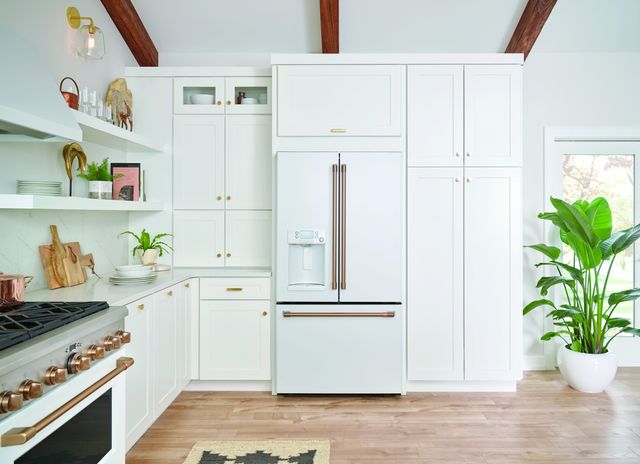 Credit: Cafe Front view of a modern white kitchen with a Cafe white french door refrigerator with ice maker