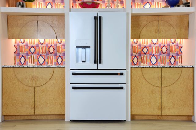 Front view of a modern kitchen with a white Cafe refrigerator