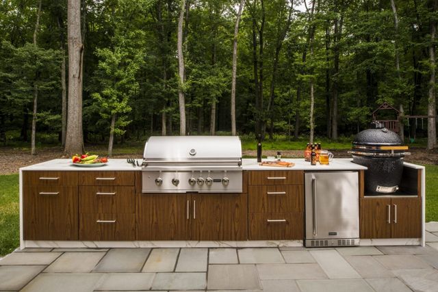 Front view of a modern outdoor kitchen with a Coyote built in grill
