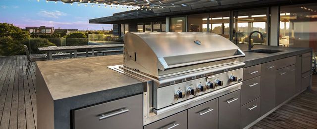 Front view of a modern outdoor kitchen with a DCS built in grill
