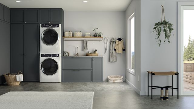 Front view of a modern laundry room with an Electrolux stacked washer and dryer