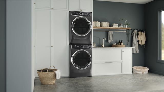 Front view of a stacked Electrolux washer and dryer in a modern laundry room