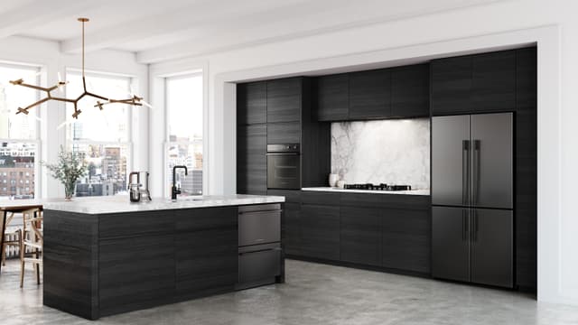 Front view of a luxury kitchen with an integrated Fisher and Paykel refrigerator Front view of a luxury kitchen with an integrated Fisher and Paykel refrigerator
