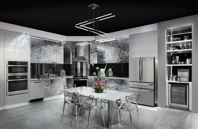 Credit: GE Front view of a luxury kitchen with stainless steel appliances, decor, and a wall oven microwave combo built in.