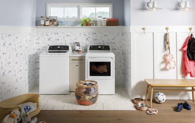 Front view of a modern laundry room and playroom with a GE top load washer and dryer