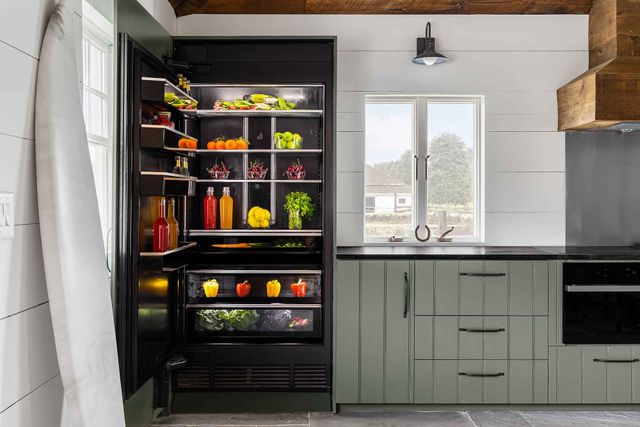 Front view of a modern kitchen with an opened JennAir 30 inch refrigerator