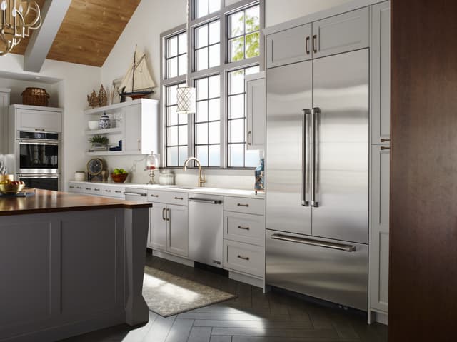 Front view of a modern kitchen with a stainless steel JennAir refrigerator