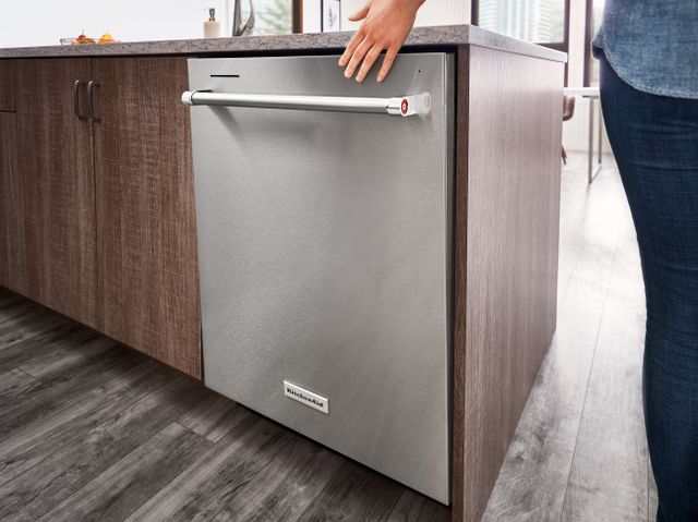 Front view of a modern kitchen with a stainless steel KitchenAid dishwasher