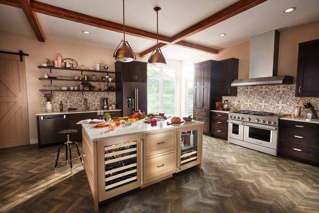 Front view of a luxury kitchen with a KitchenAid undercounter refrigerator and wine cooler 