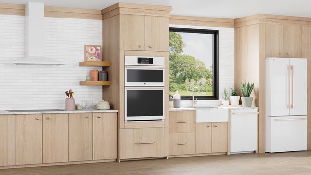 Front view of a modern kitchen with white LG signature appliances, and a wall oven microwave and combo front and center 