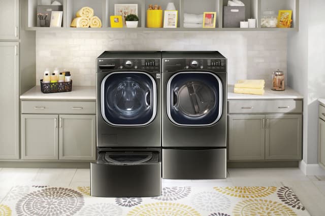 Front view of a casual laundry room with an LG black washer and dryer