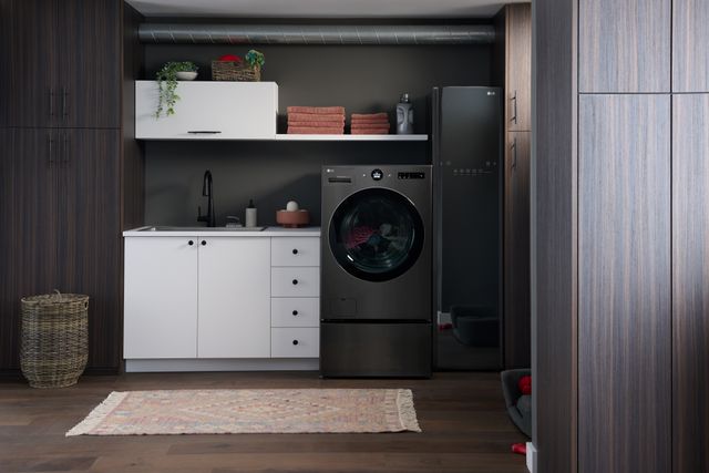 Front view of a luxury laundry room with an LG washer dryer combo and drying cabinet
