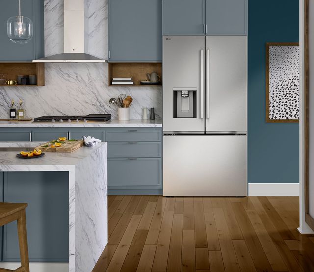 Front view of a modern kitchen with the LG 36" 23.7 Cu. Ft. PrintProof™ Stainless Steel Counter Depth MAX™ with Zero Clearance™ French Door Refrigerator