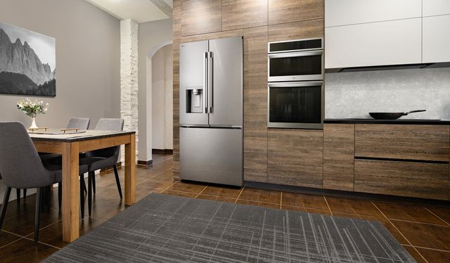 Front view of a modern kitchen with the LG 36" 23.7 Cu. Ft. PrintProof™ Stainless Steel Counter Depth MAX™ with Zero Clearance™ French Door Refrigerator 