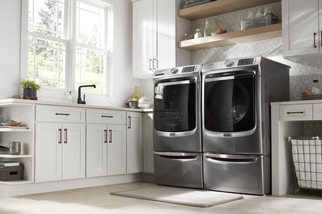 Front view of a modern laundry room with a Maytag washer and dryer ser