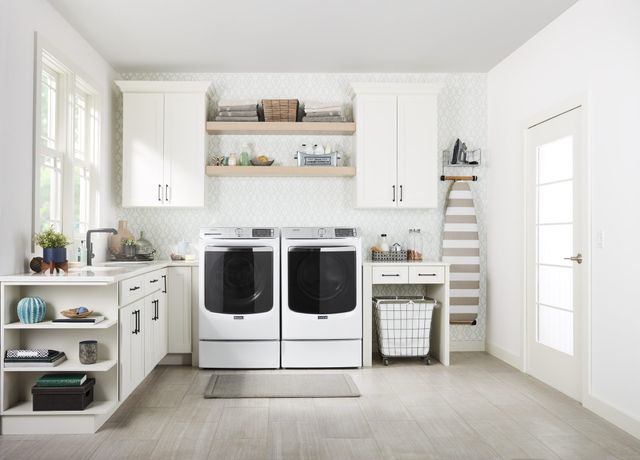 Front view of a modern laundry room with a Maytag washer and dryer