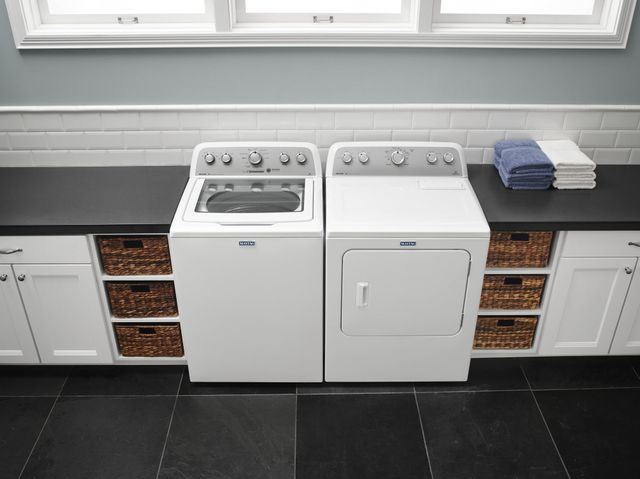 Front view of a modern laundry room with a white Maytag laundry pair