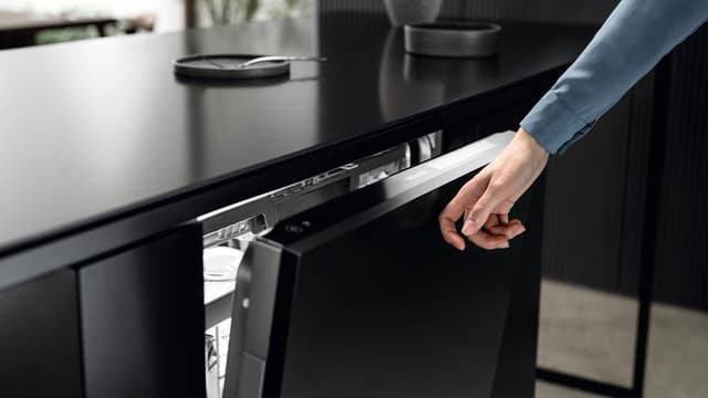 Front view of a Miele dishwasher being closed with Knock2Open Front view of a Miele dishwasher being closed with Knock2Open