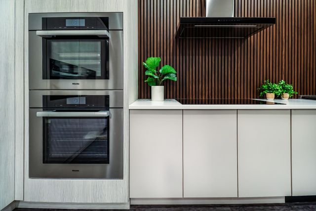 Chef using Miele induction cooktop