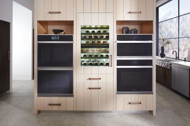 Front view of a modern kitchen with two Monogram double wall ovens