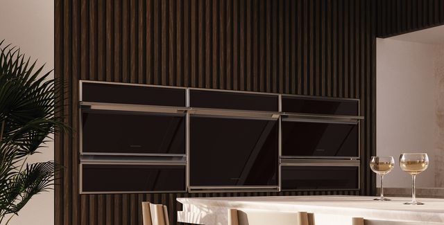 Front view of a modern kitchen with Monogram wall ovens