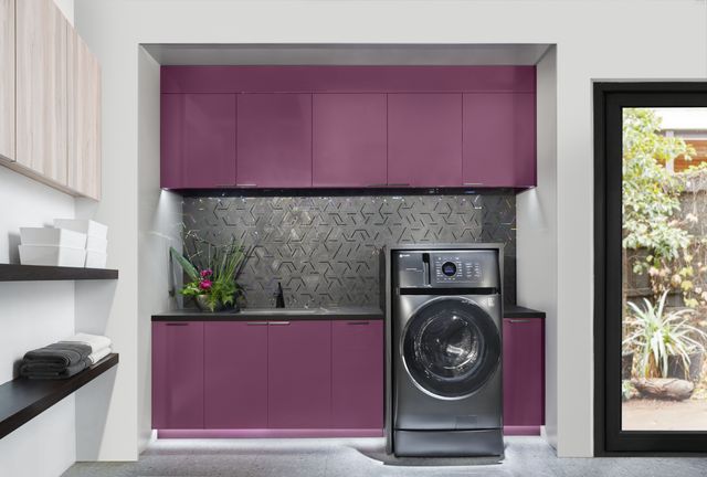 Front view of a modern laundry room with a GE Profile washer and dryer combo