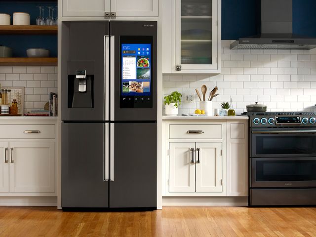 Credit: Samsung Front view of a modern kitchen with a Samsung four door refrigerator with a screen