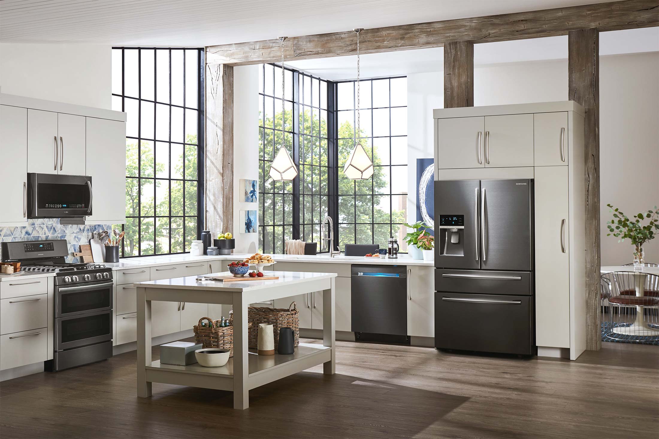 Modern kitchen featuring a full suite of Samsung black stainless steel appliances