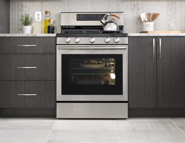 Front view of a Samsung freestanding gas range in use