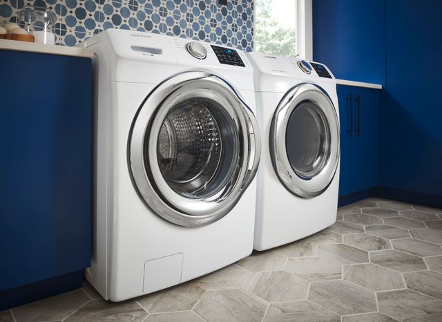 Front view of a modern laundry room with a white Samsung front load washer and dryer
