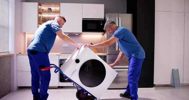 Front view of two men installing a washing machine Front view of two men installing a washing machine