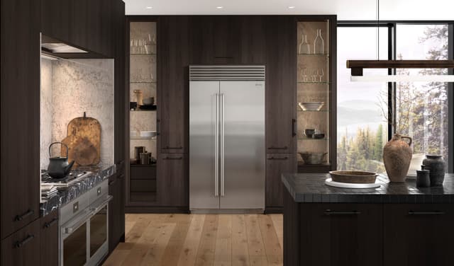 Front view of a luxury kitchen with a Sub-Zero refrigerator and Wolf range